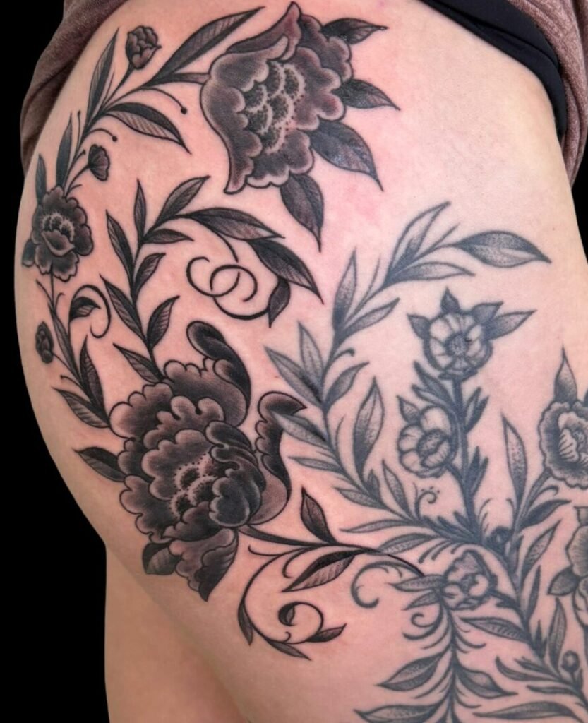 floral b&g thigh tattoo